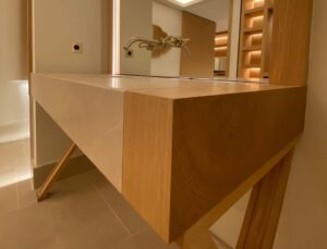 Meuble vasque suspendu sur mesure dans une salle de bains contemporaine avec robinetterie murale et finitions haut de gamme.